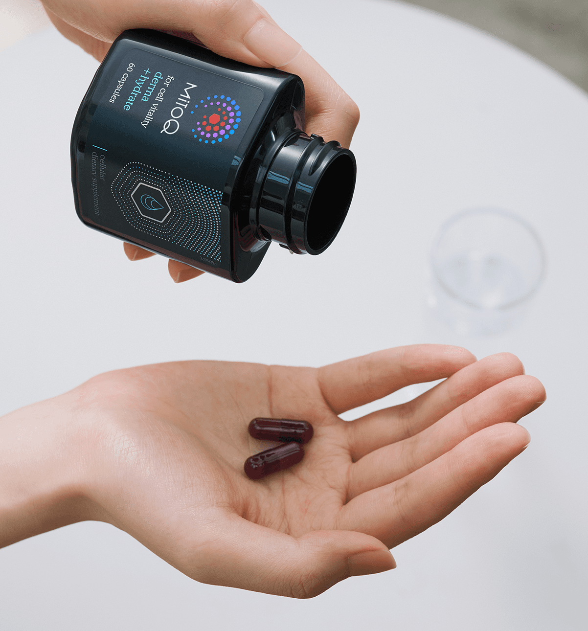 MitoQ derma +hydrate pills in hand